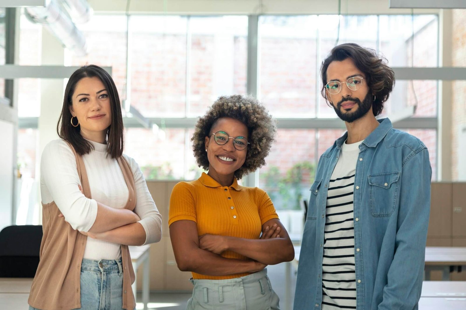 multiracial-coworkers-looking-at-camera-standing-in-bright-spacious-co-working-office-space-.jpg